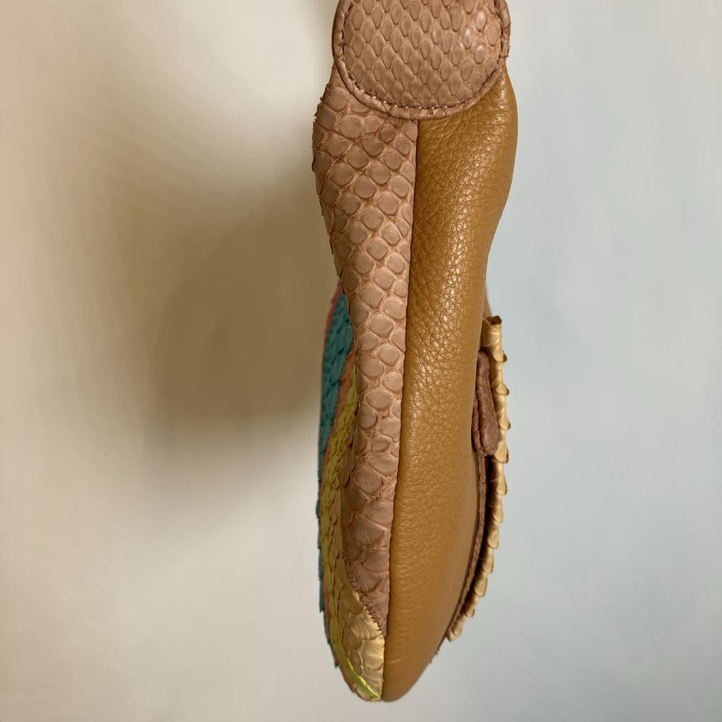 A tan leather and python-skin textured handbag shown from a side profile view against a plain light background.