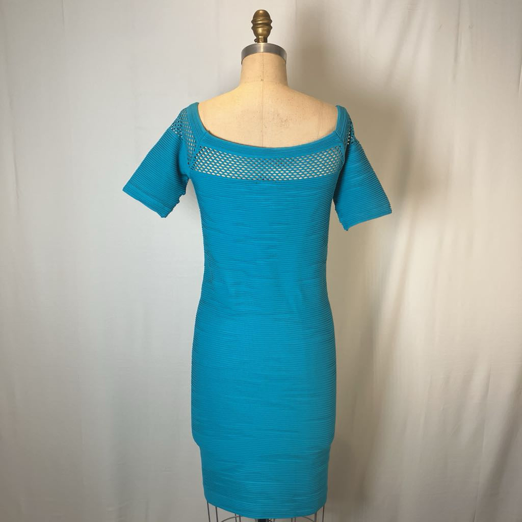 A turquoise blue short-sleeve knit dress displayed on a beige dress form mannequin against a light gray fabric backdrop.