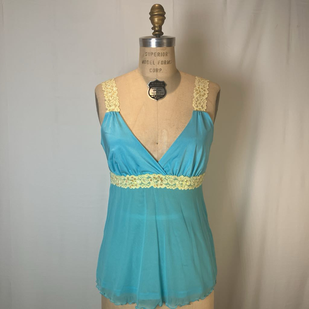 A turquoise blue babydoll nightgown top with pale yellow lace trim on the straps and waistband, displayed on a vintage mannequin torso against a neutral light gray fabric backdrop.
