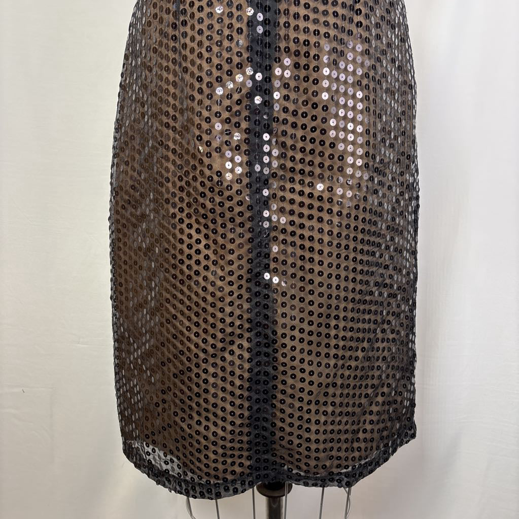 A black sequined mesh skirt or cover-up displayed on a dress form against a plain off-white background.