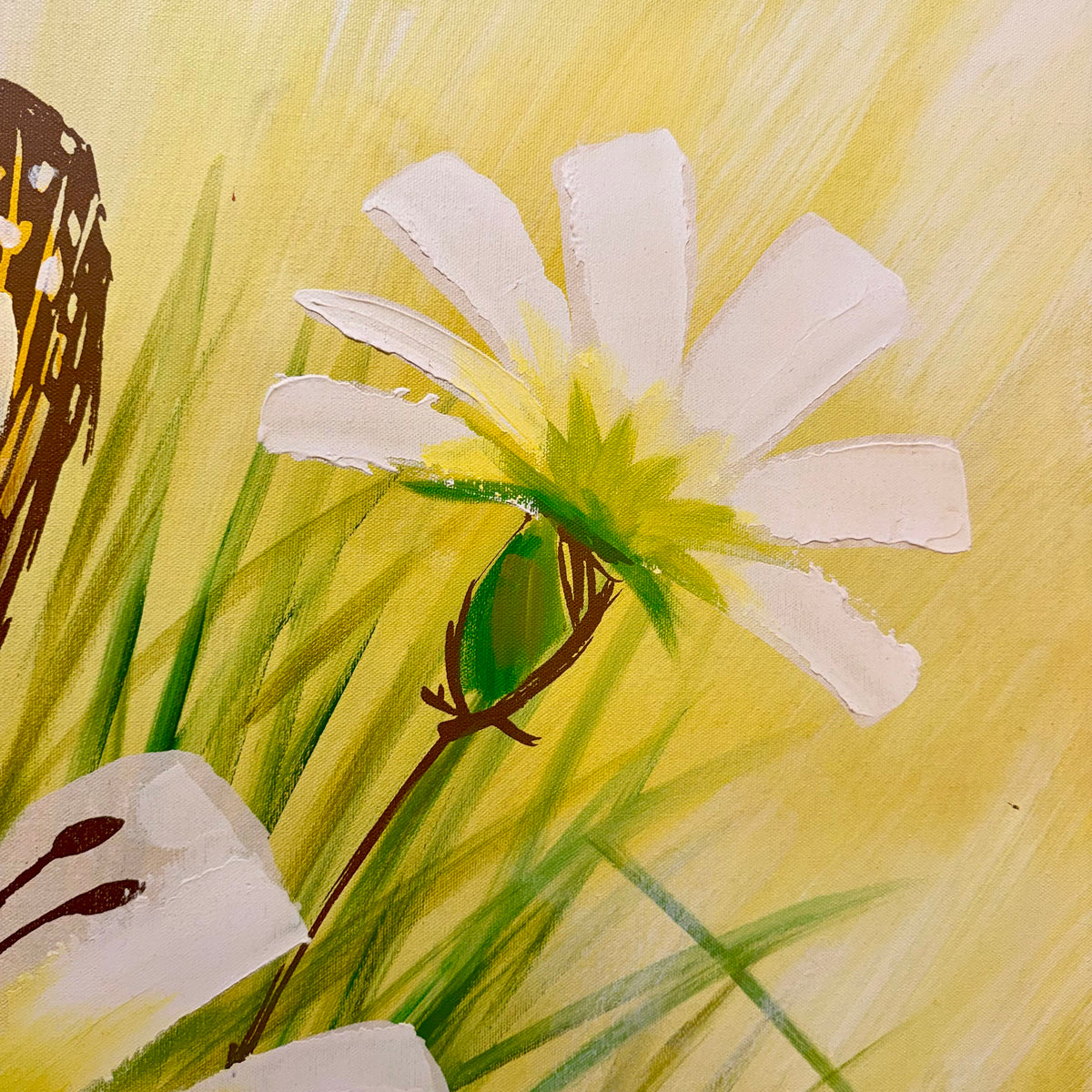 A close-up of a painted floral scene with a white flower featuring a yellow-green center, green grass-like strokes, and a warm yellow background.