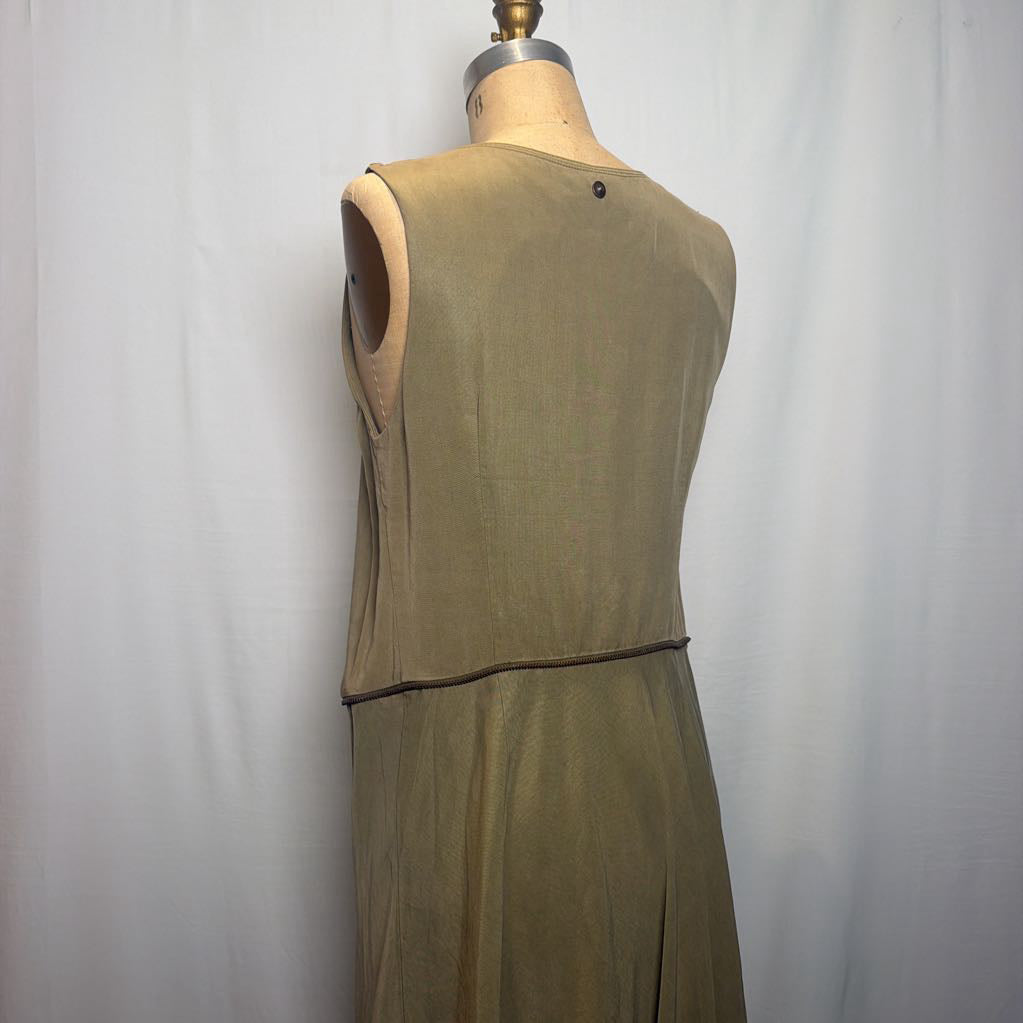 A sleeveless olive green dress displayed on a beige mannequin torso against a white fabric backdrop.
