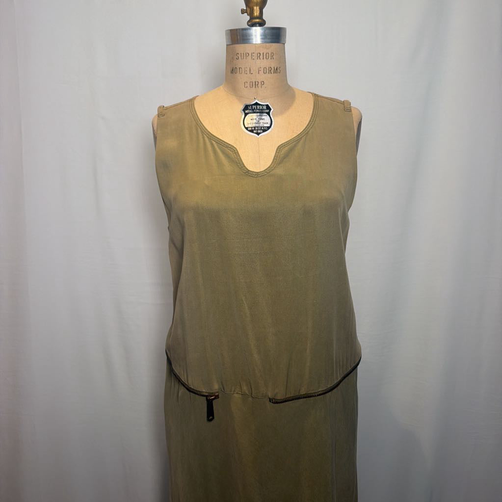 A sleeveless olive green dress displayed on a vintage wooden dress form against a white fabric backdrop.