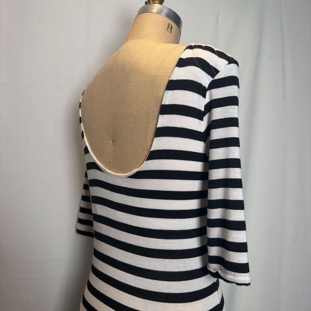 A black and white horizontally striped knit top displayed on a beige dress form mannequin against a light gray fabric backdrop.