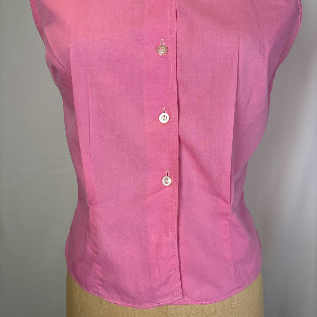 A pink sleeveless button-up blouse displayed on a beige dress form against a plain light gray background.