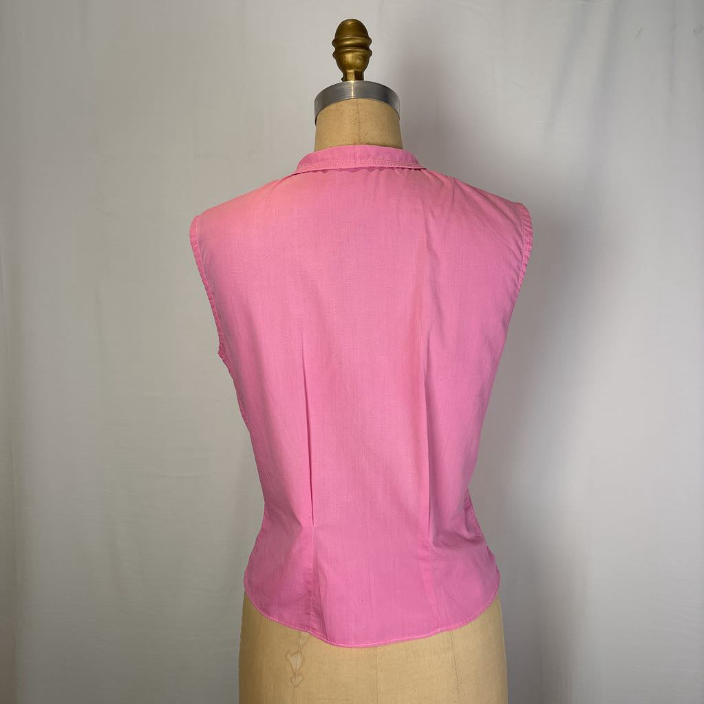 A pink sleeveless collared top displayed on a dress form from the back, set against a plain light gray fabric backdrop.