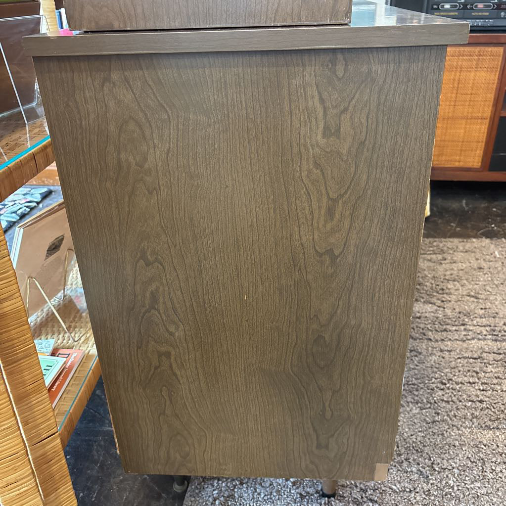 The side of a large wooden hutch in a store setting.