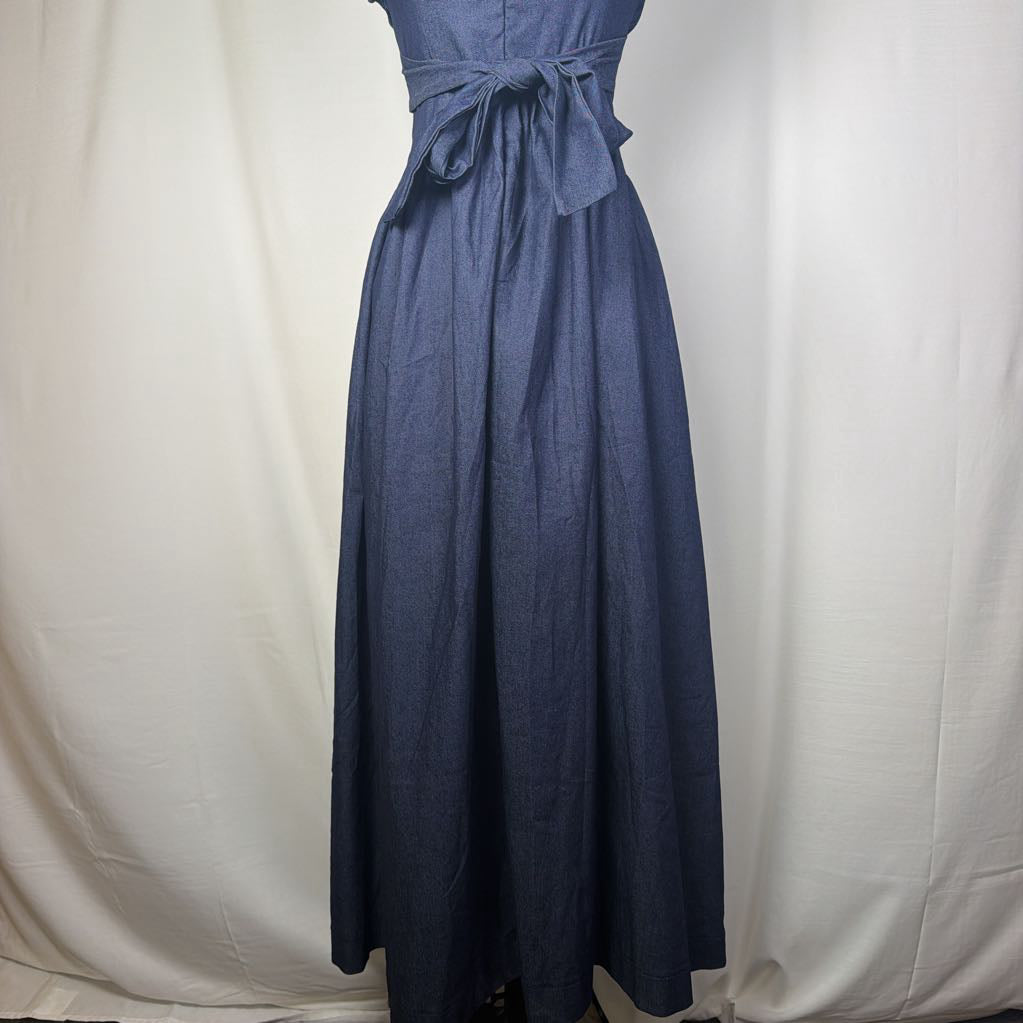 A sleeveless blue maxi dress with a matching waist tie, displayed on a mannequin against a white fabric backdrop.