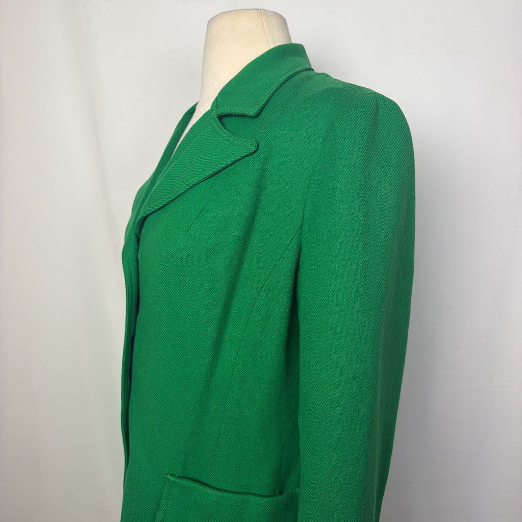 A bright green textured blazer jacket displayed on a cream mannequin torso against a white studio background.