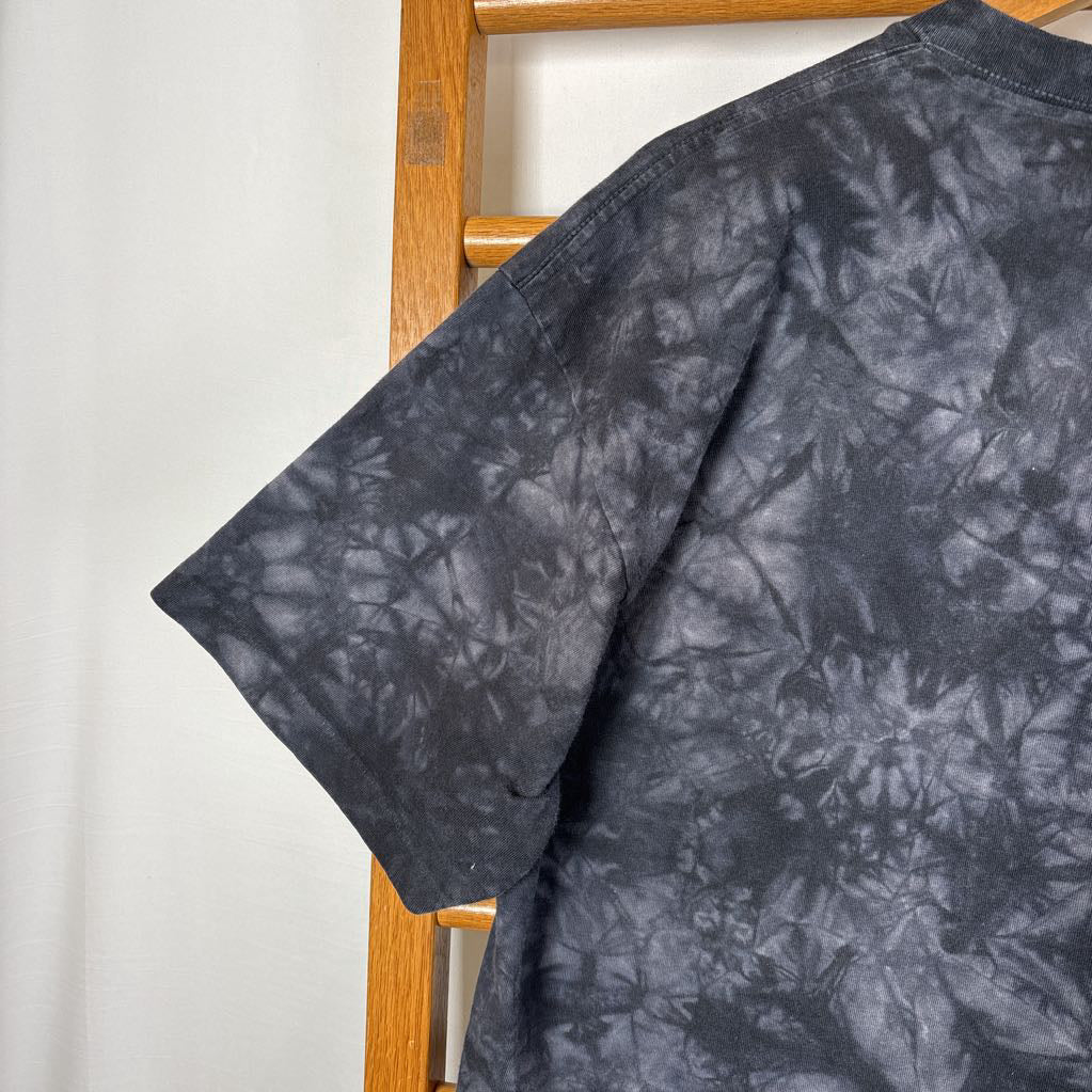 A dark gray tie-dye short sleeve t-shirt on a wooden rack against a white background.