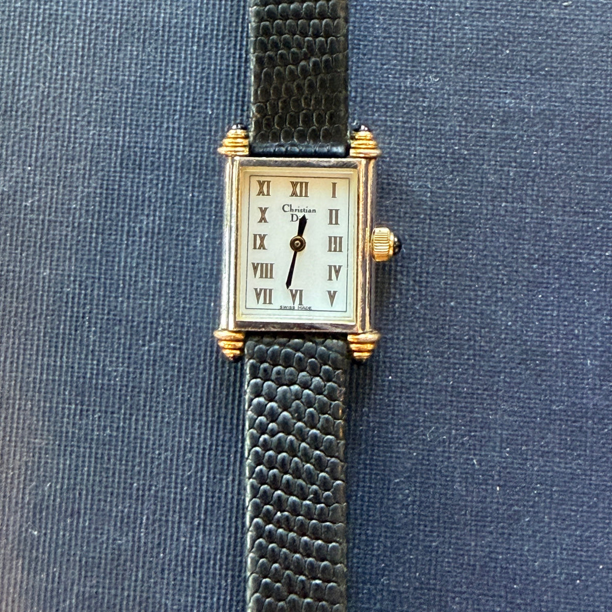 Close up of the face of a Vintage Christian Dior Tank Watch showing part of the band
