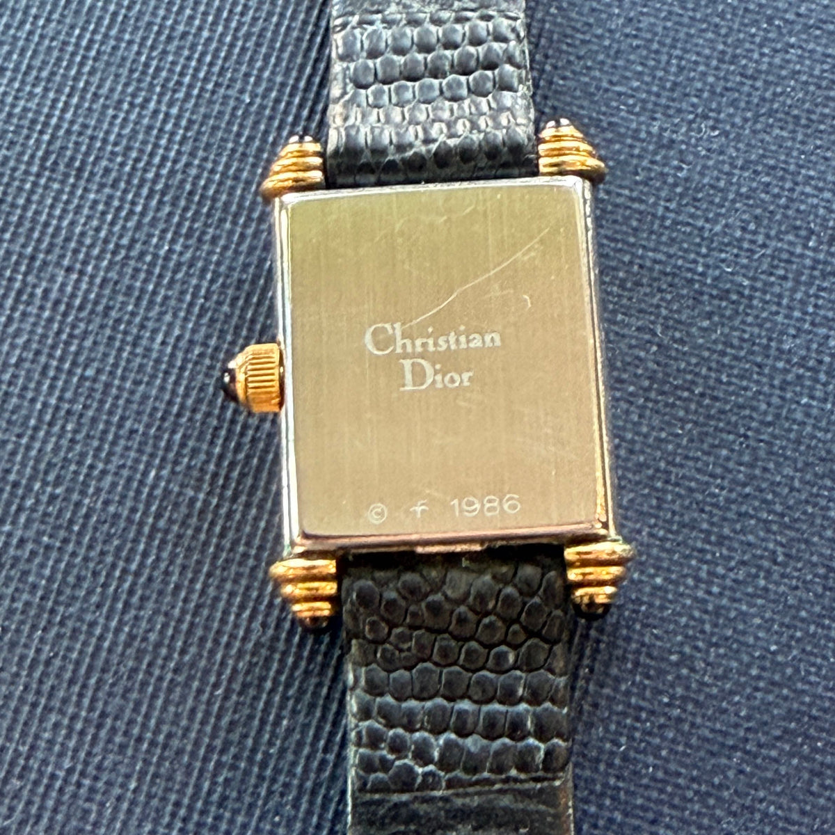 Showing the back of the Christian Dior tank watch, 1986 & Christian Dior printed on the back of the watch
