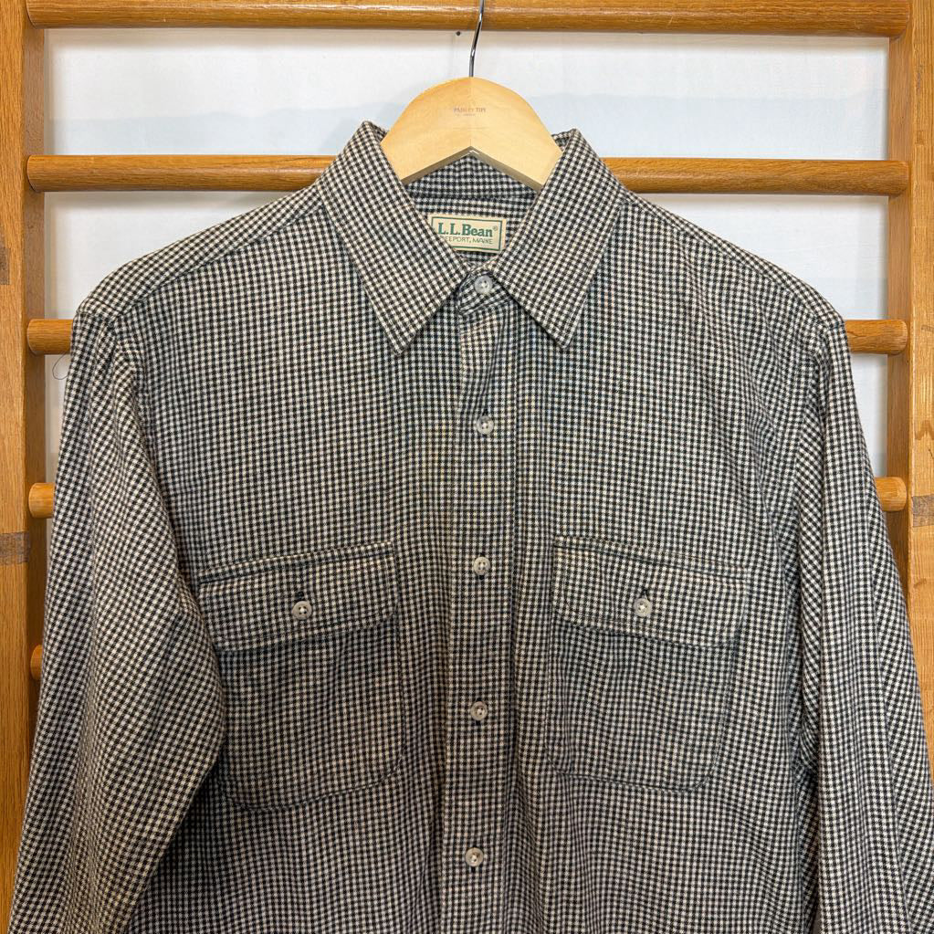 A button-up shirt on a wooden rack.
