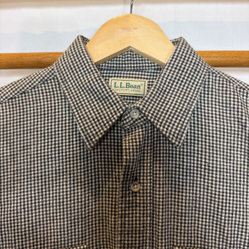 A button-up shirt on a wooden rack.