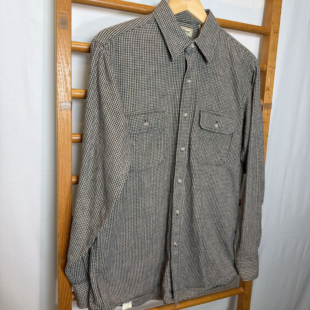 A button-up shirt on a wooden rack.