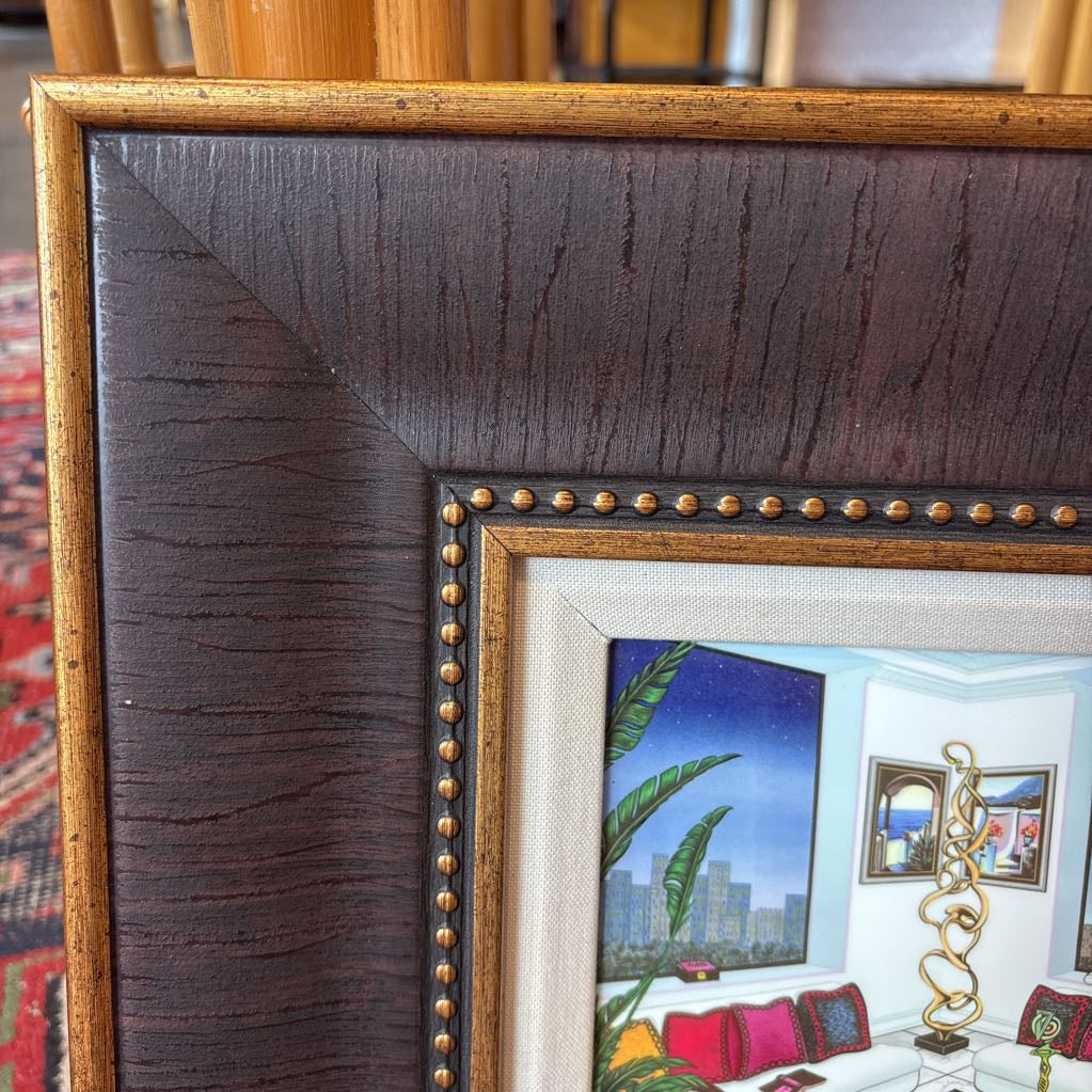 A framed artwork of a room and a nigh time cityscape outside of the windows.