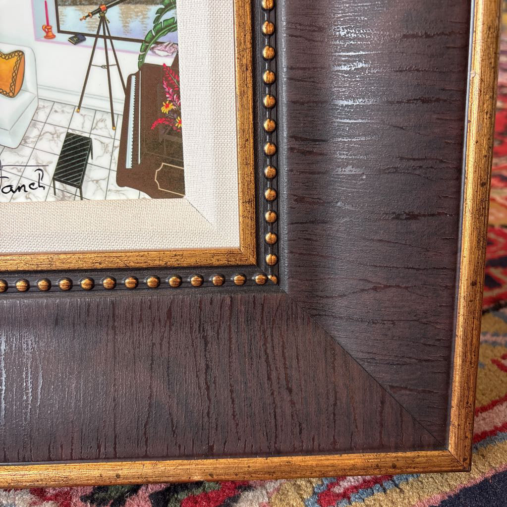 A framed artwork of a room and a nigh time cityscape outside of the windows.