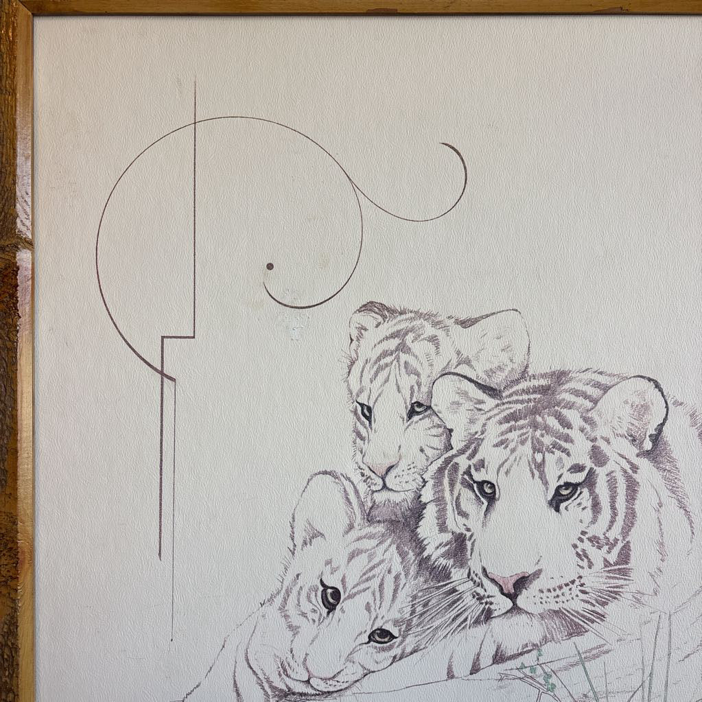 A white artwork of a tiger and cubs in a thick wooden frame.