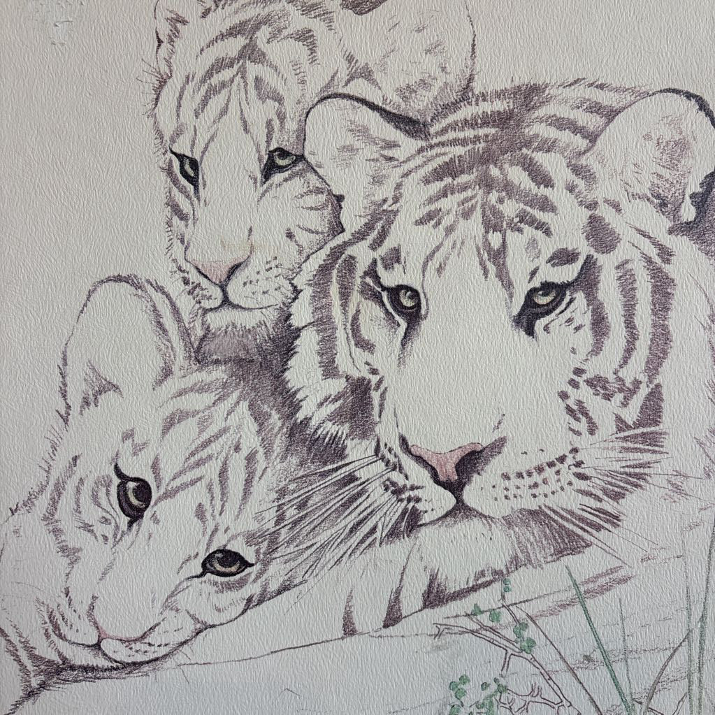 A white artwork of a tiger and cubs in a thick wooden frame.