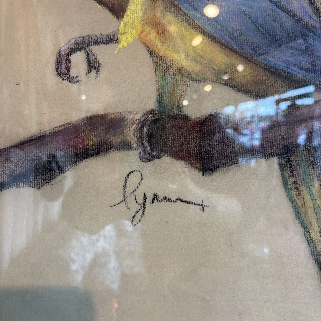 A vintage looking framed artwork of a blue and yellow Macaw on a branch with a signature under it.
