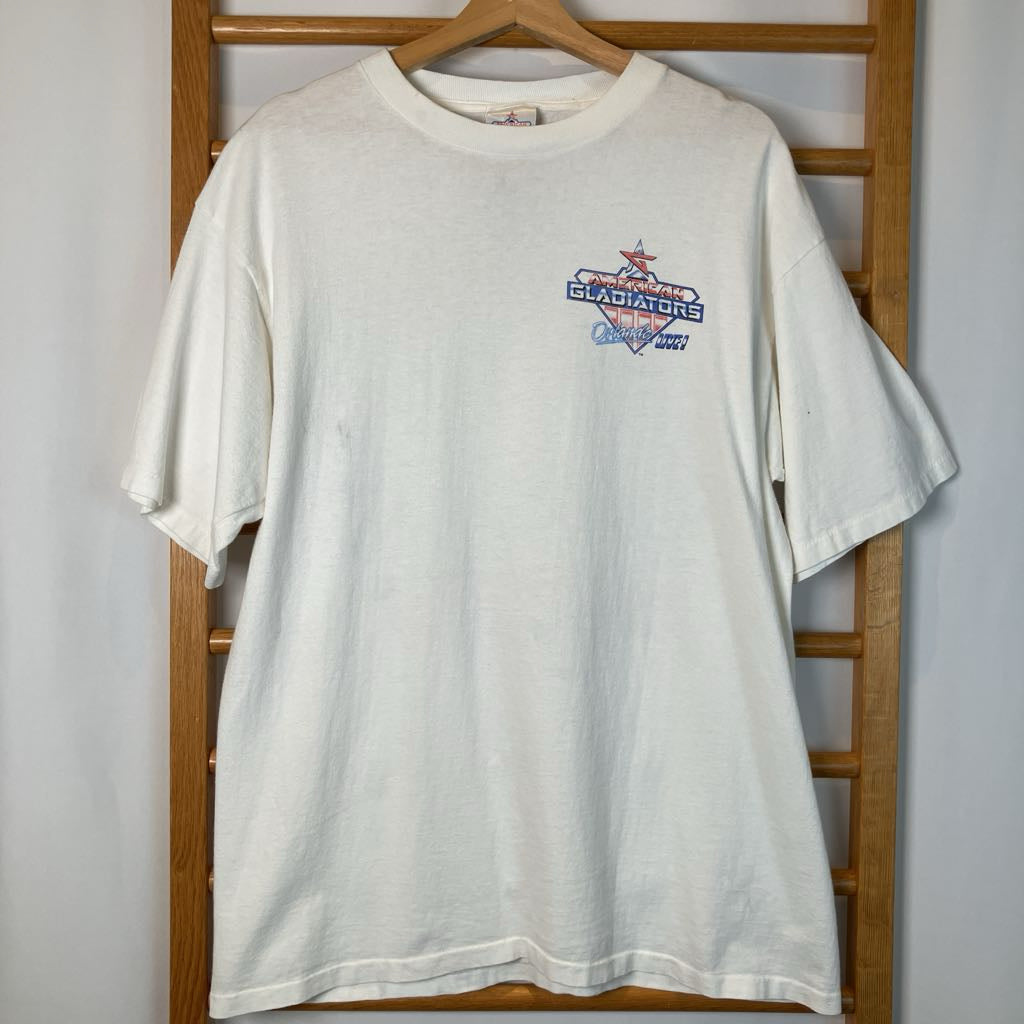 White t-shirt with a logo on a wooden rack against a white wall