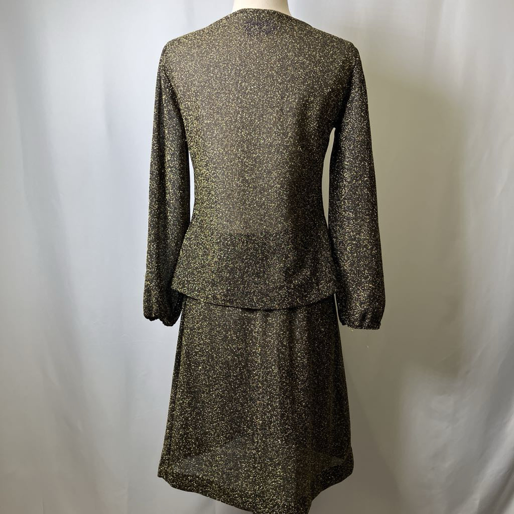 Two-piece suit with a top and skirt on a mannequin against a white background