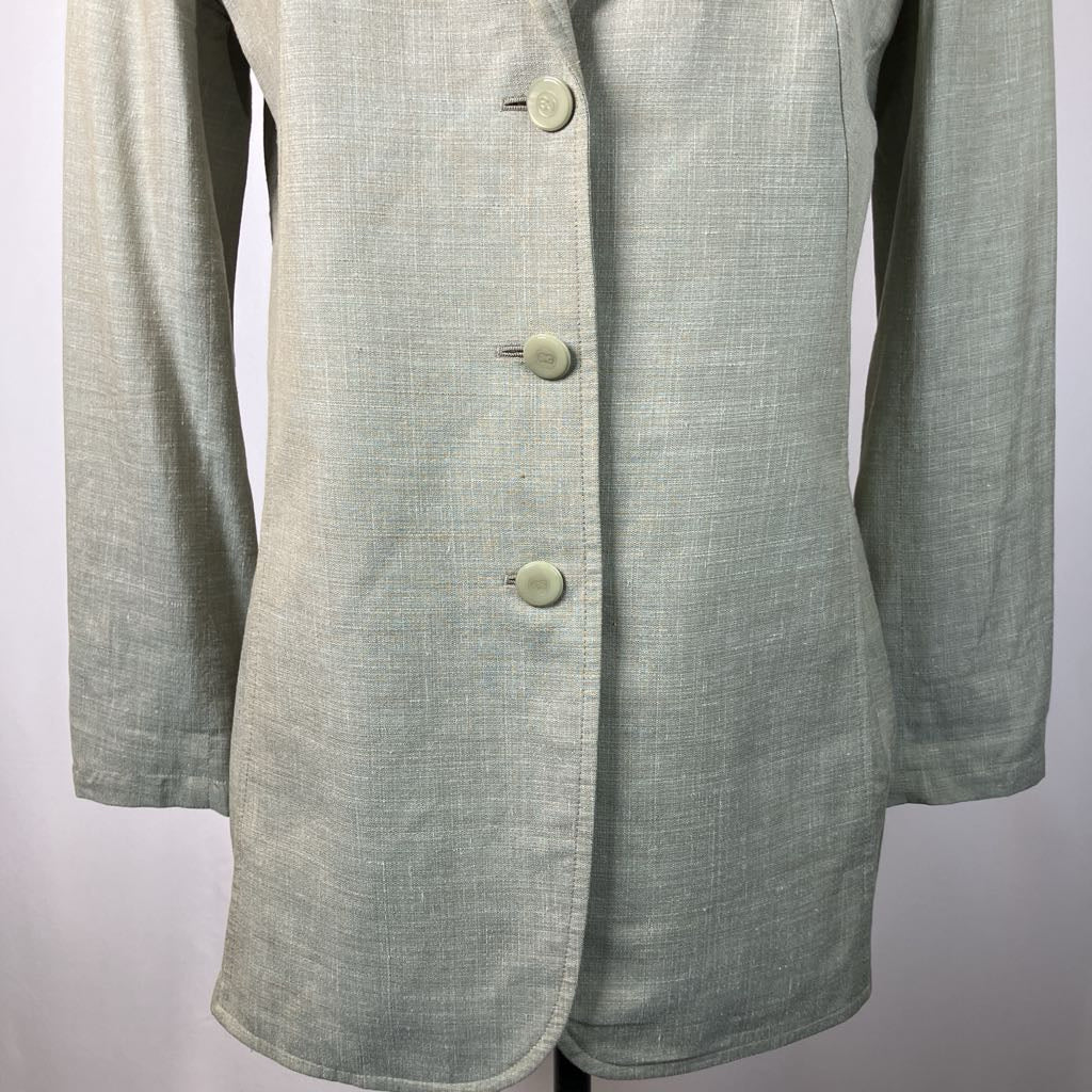 close up of buttons on outerwear against a white background