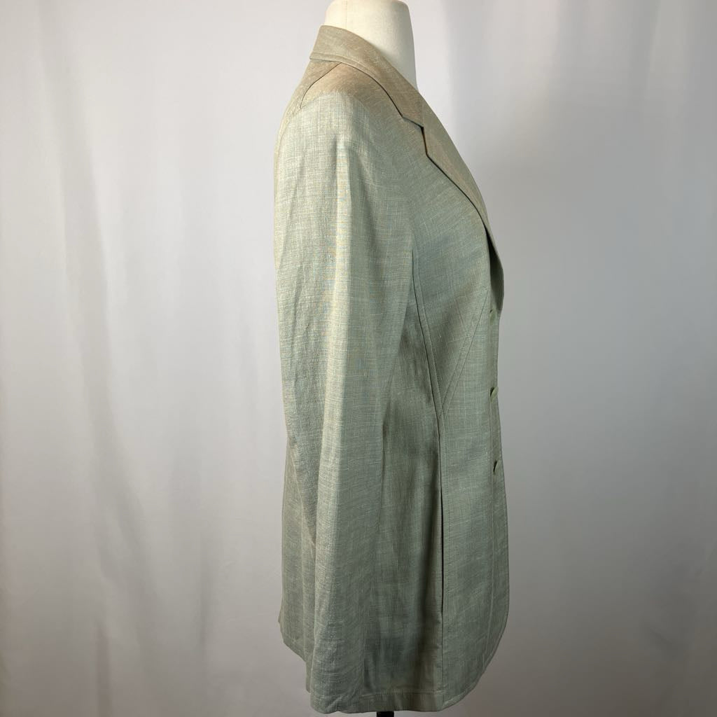 Green jacket on a mannequin against a plain background