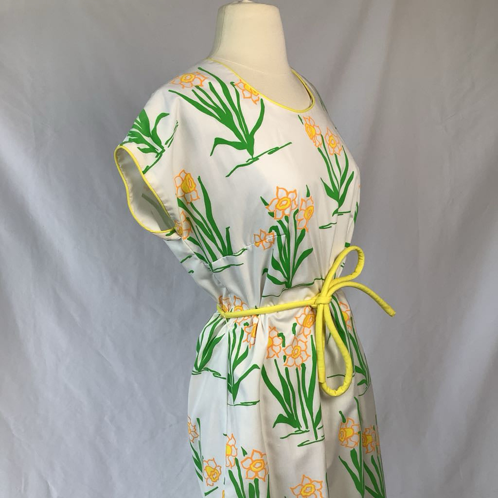 Dress with floral pattern on a mannequin against a plain background