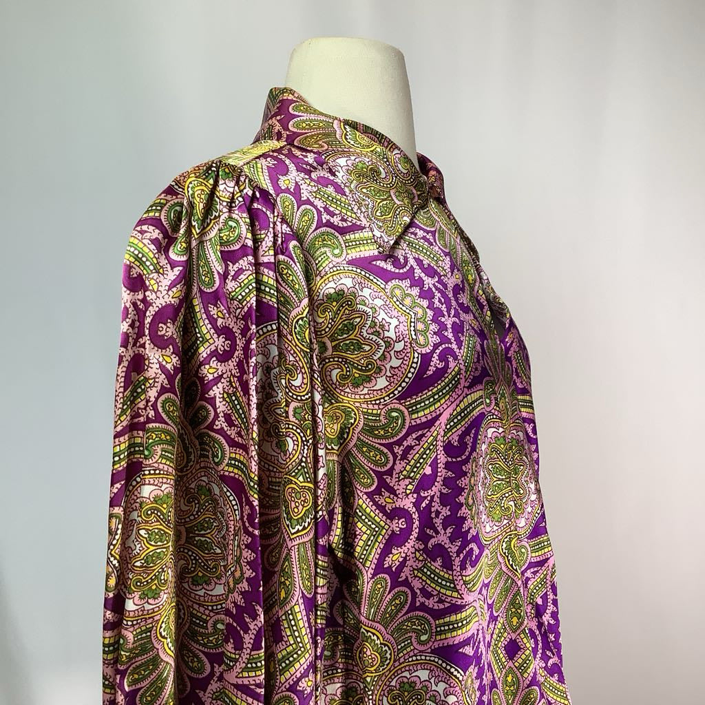 Purple and green patterned shirt on a mannequin against a gray background