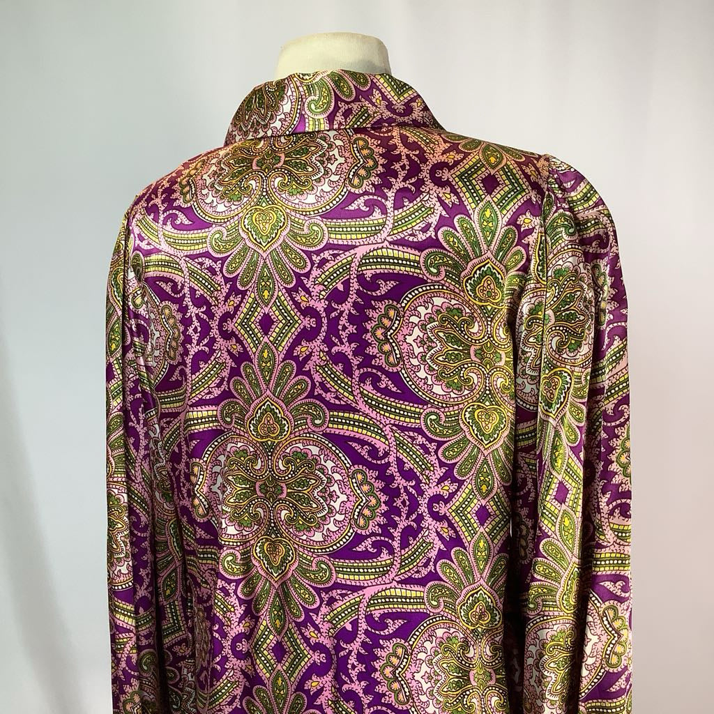 Purple and green patterned shirt on a mannequin against a white background