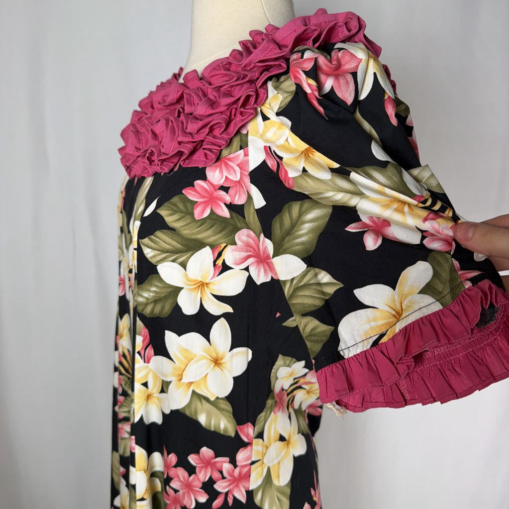 long floral dress against white background with pink ruffles