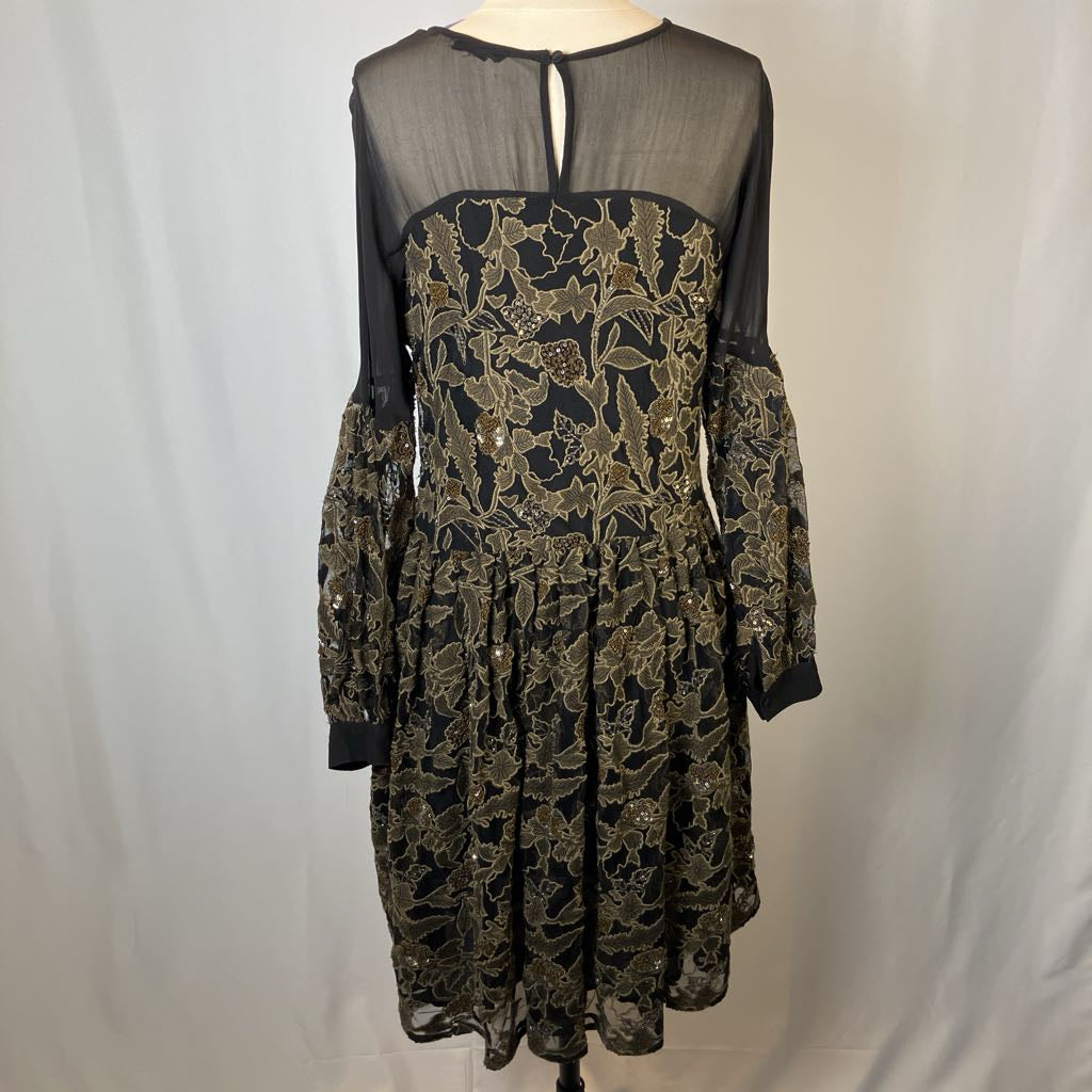 Black lace dress with sheer sleeves on a white background