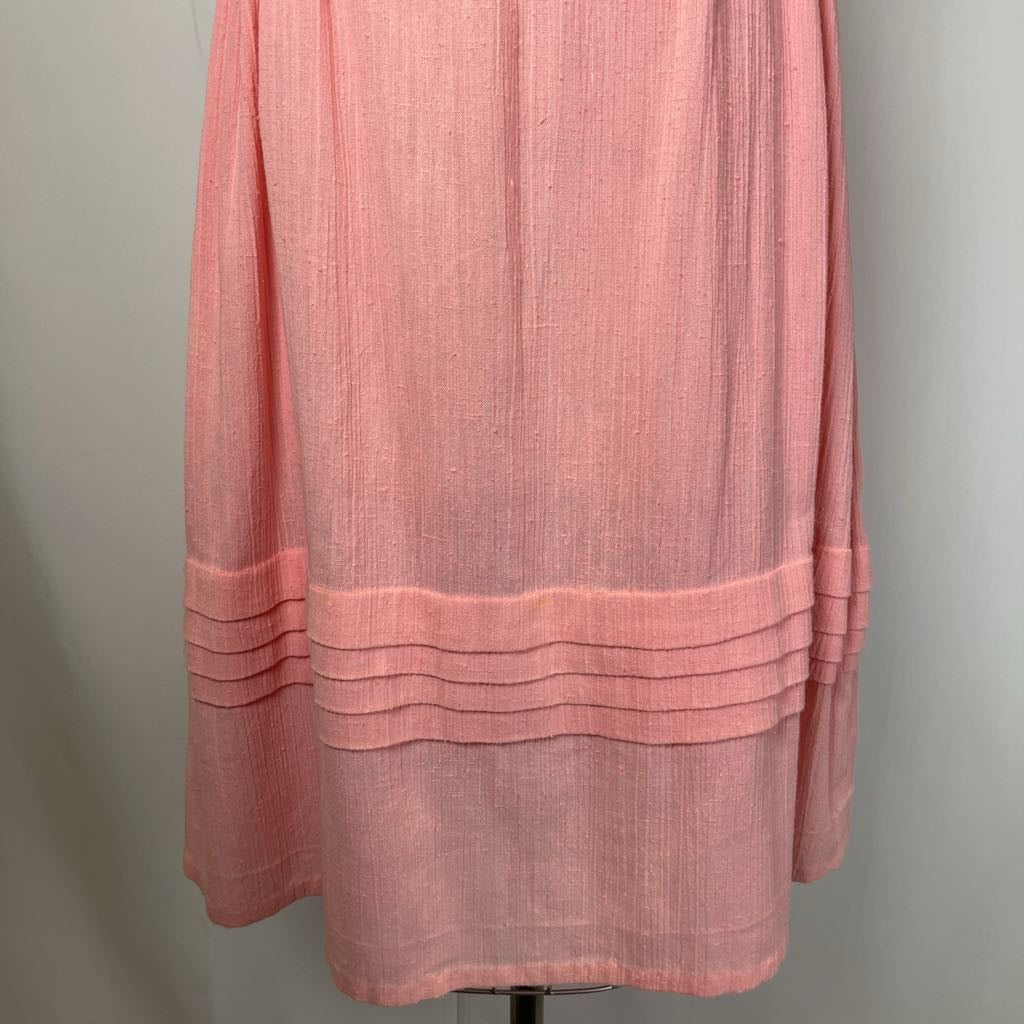Pink layered dress on a mannequin against a plain background