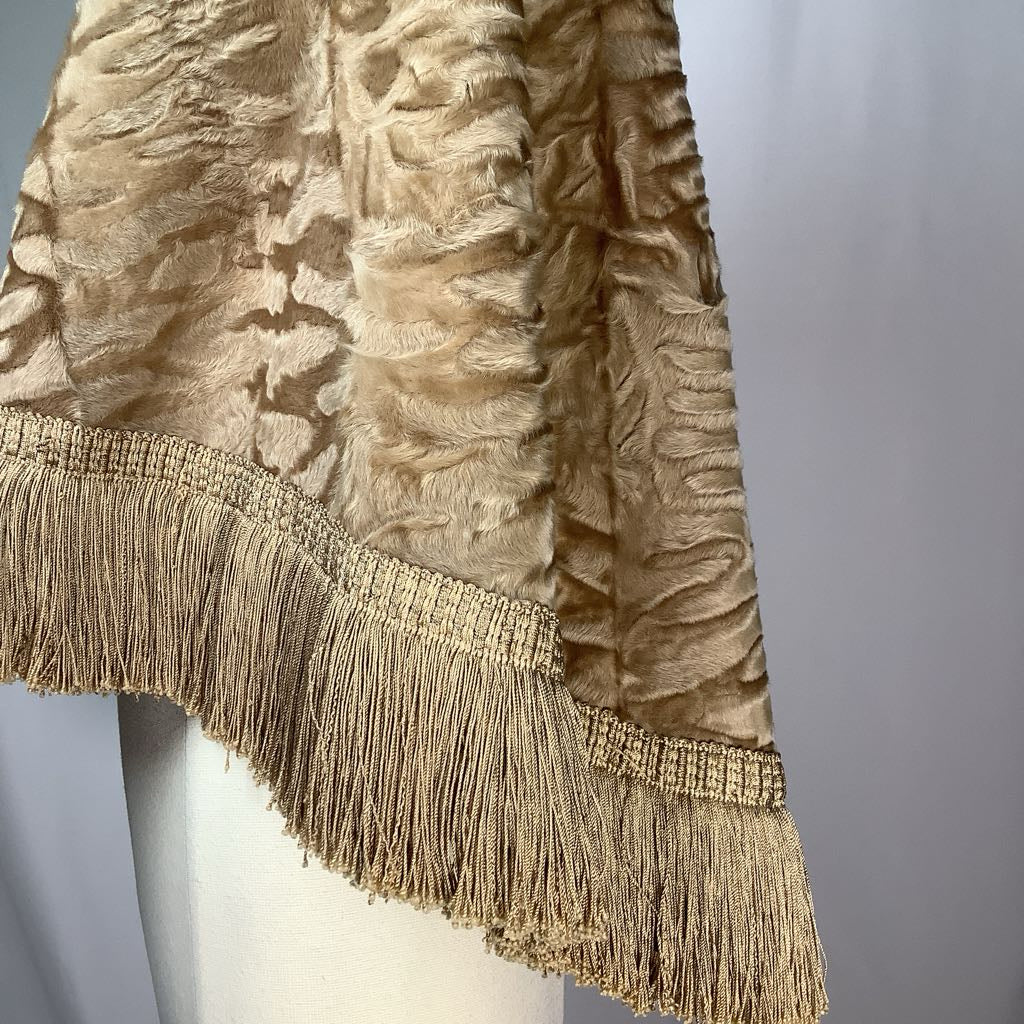 Textured fabric with fringes on a mannequin against a gray background