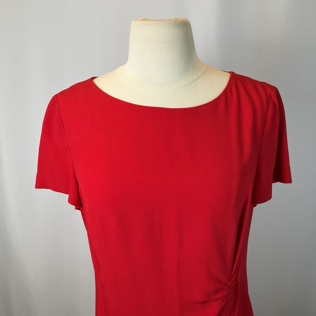 Red dress on a mannequin against a gray background
