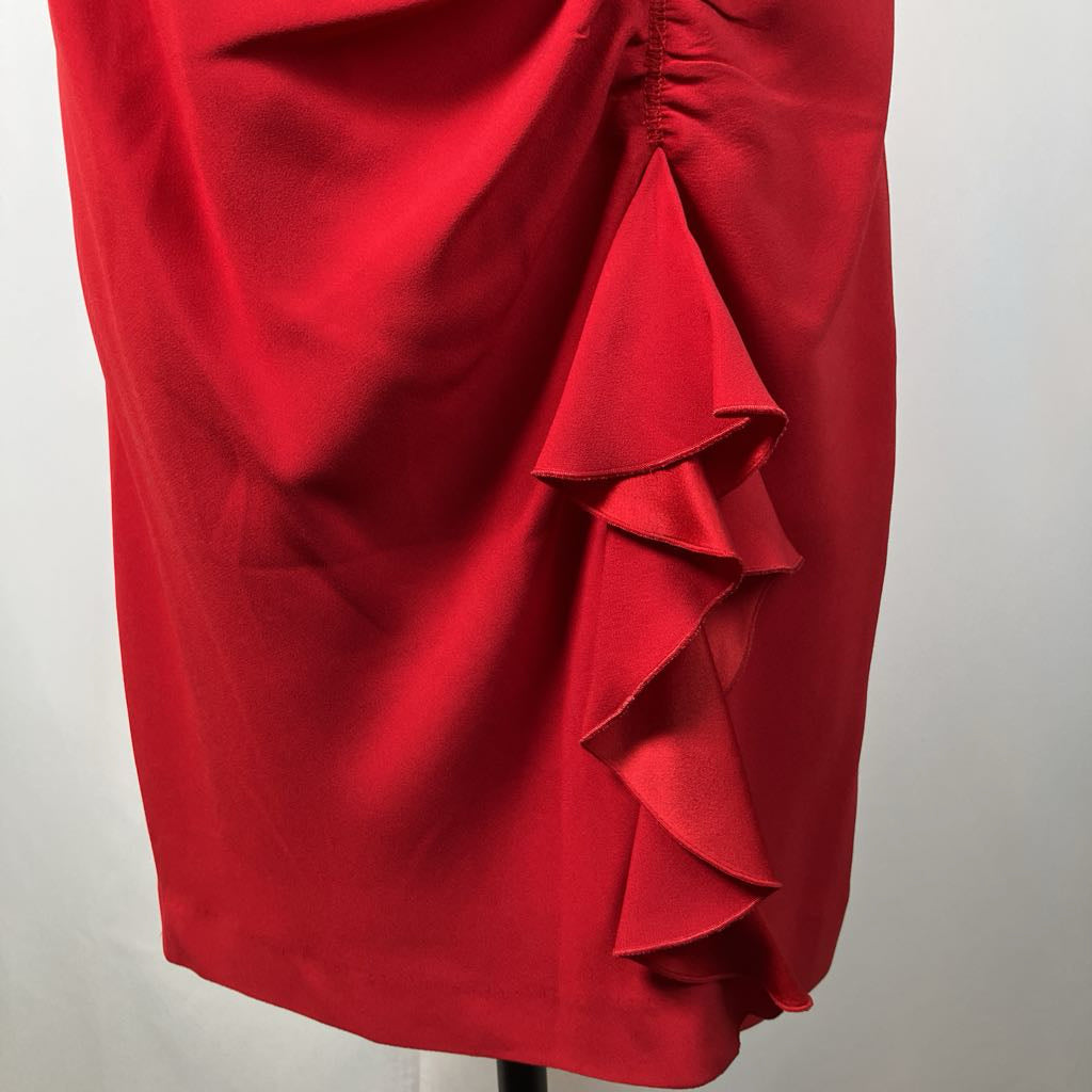 Red ruffled skirt on a mannequin against a white background