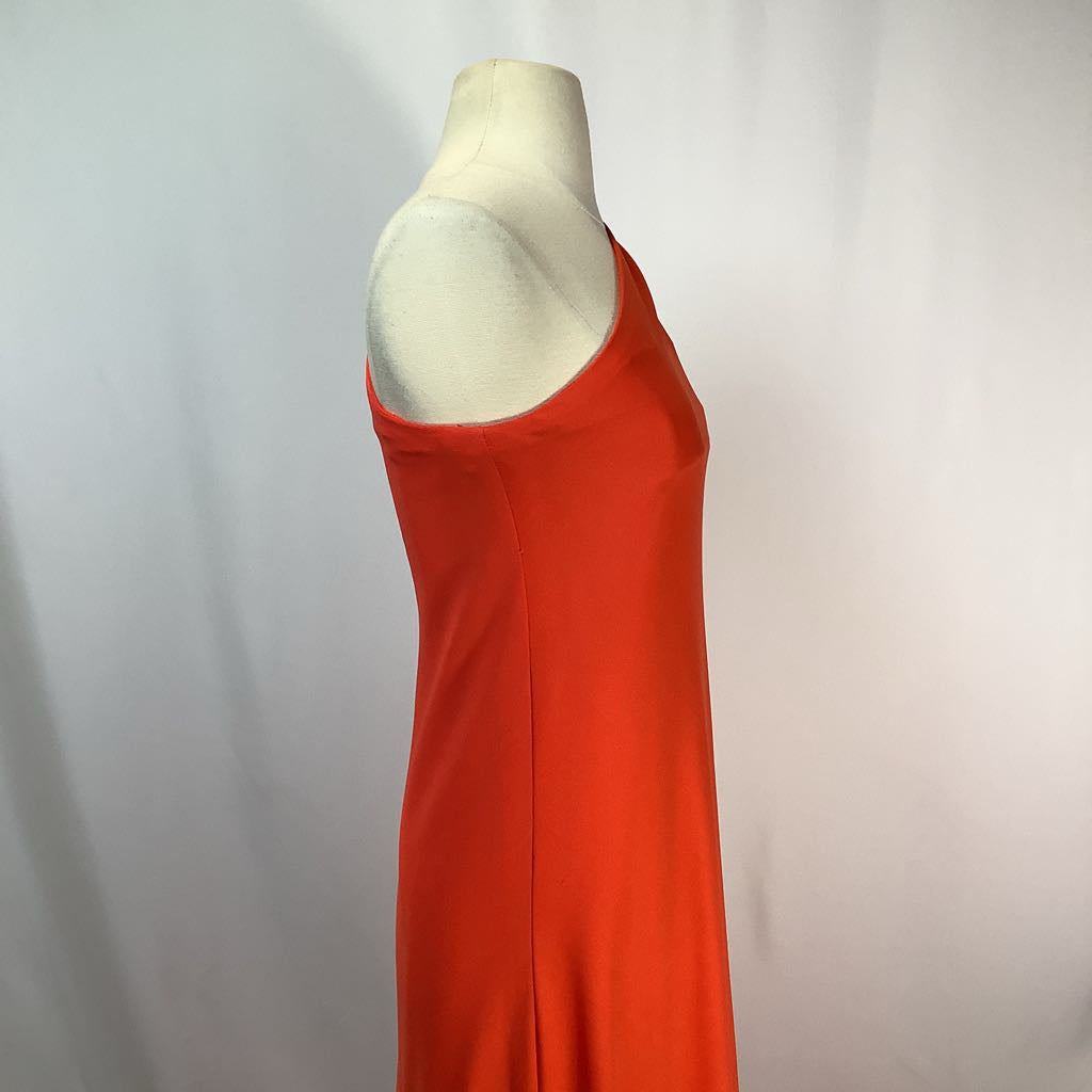 Mannequin wearing an orange dress against a plain background