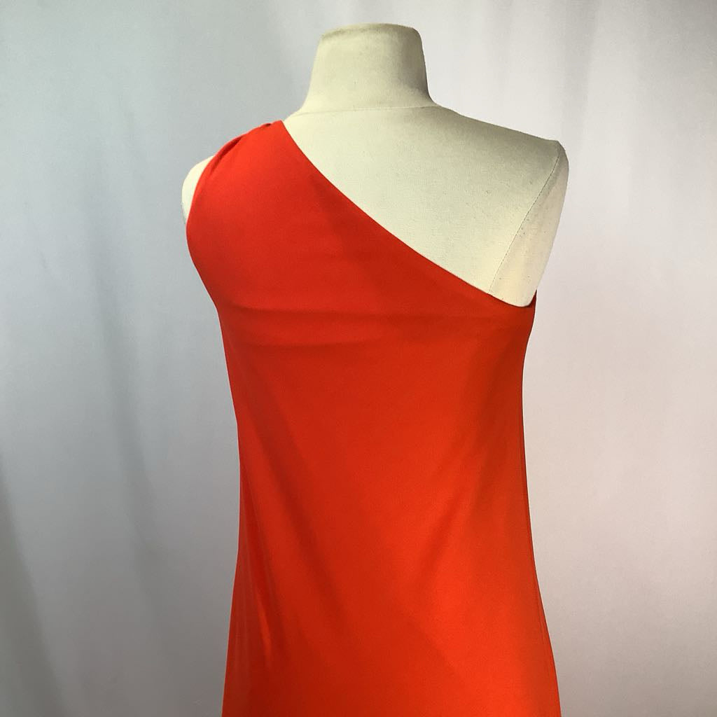 Red dress on a mannequin against a plain background