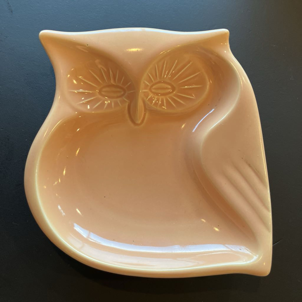 Ceramic owl-shaped dish on a dark background