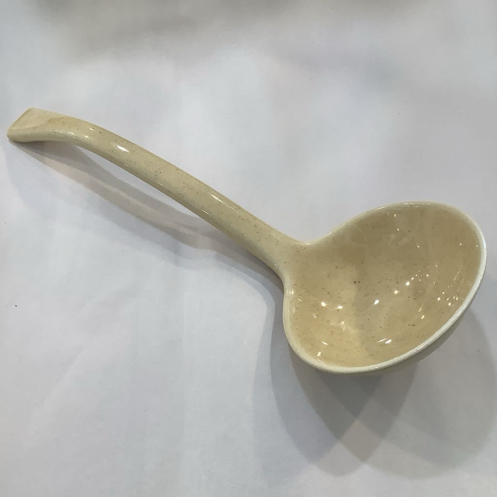 Beige ceramic ladle on a white background
