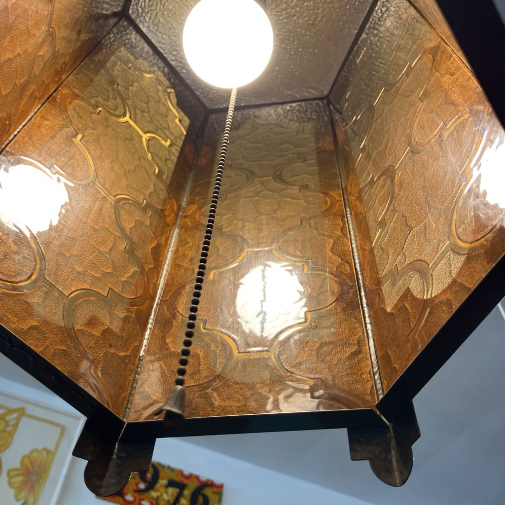 Decorative ceiling light fixture with embossed design and visible bulb