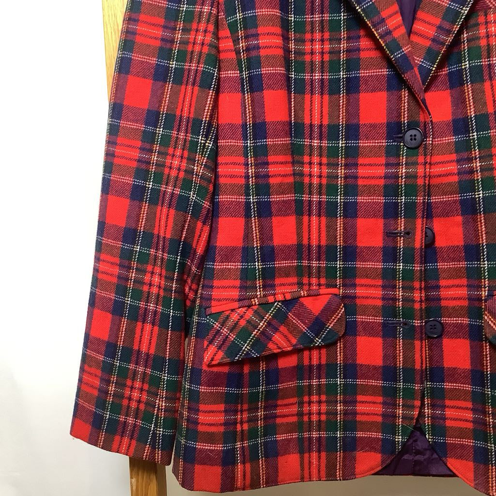 Red and blue plaid coat on a mannequin against a white background