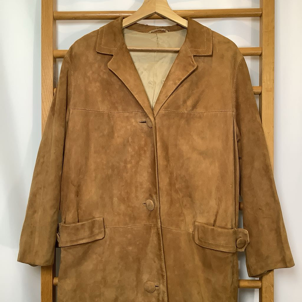 Brown suede coat on a wooden hanger against a white wall