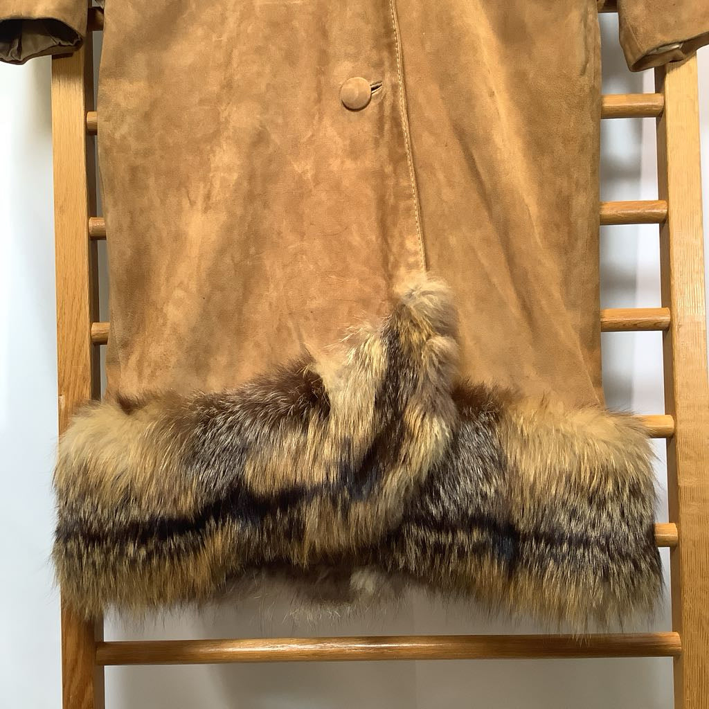 Brown suede jacket with fur trim on a wooden rack.