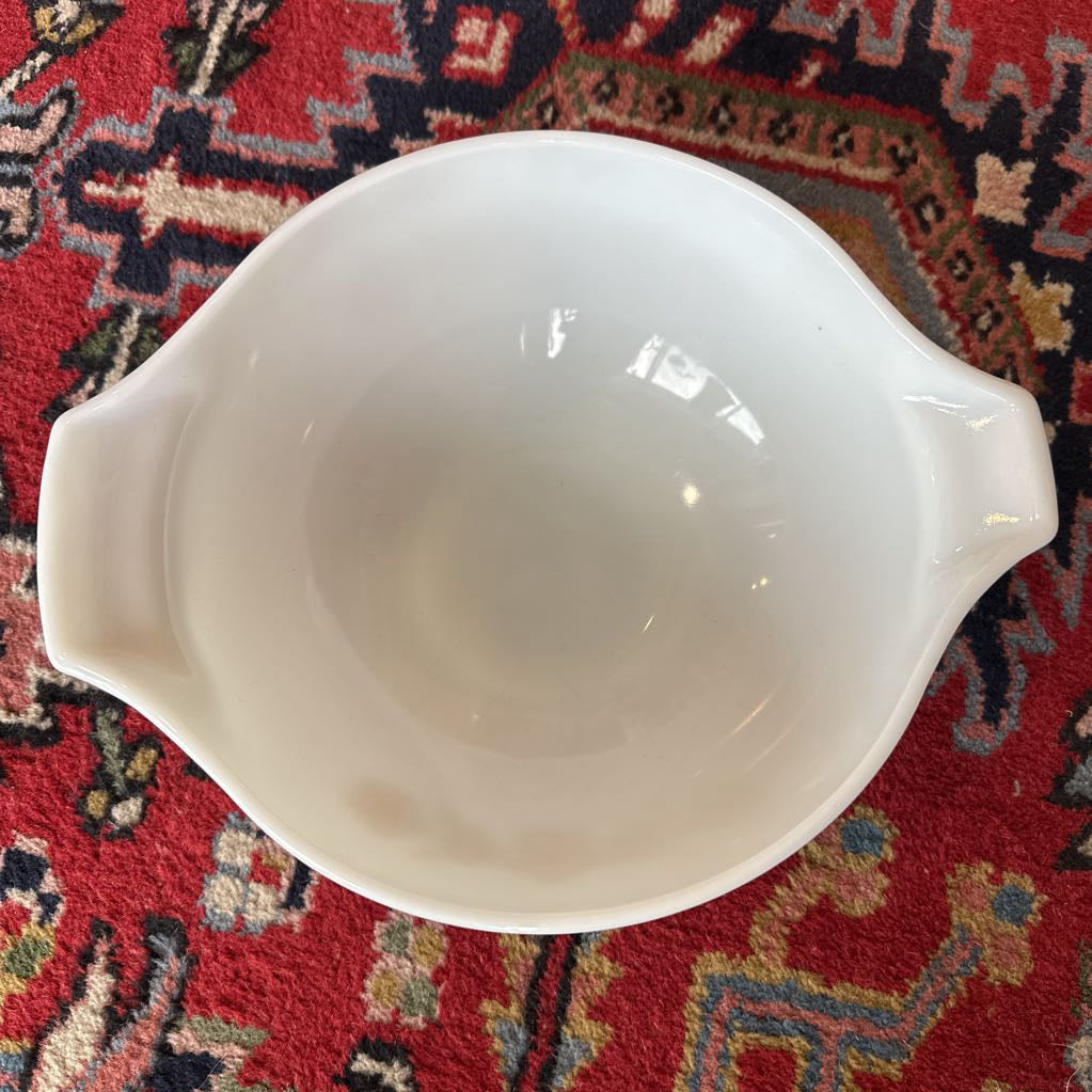 White ceramic bowl on a red patterned rug