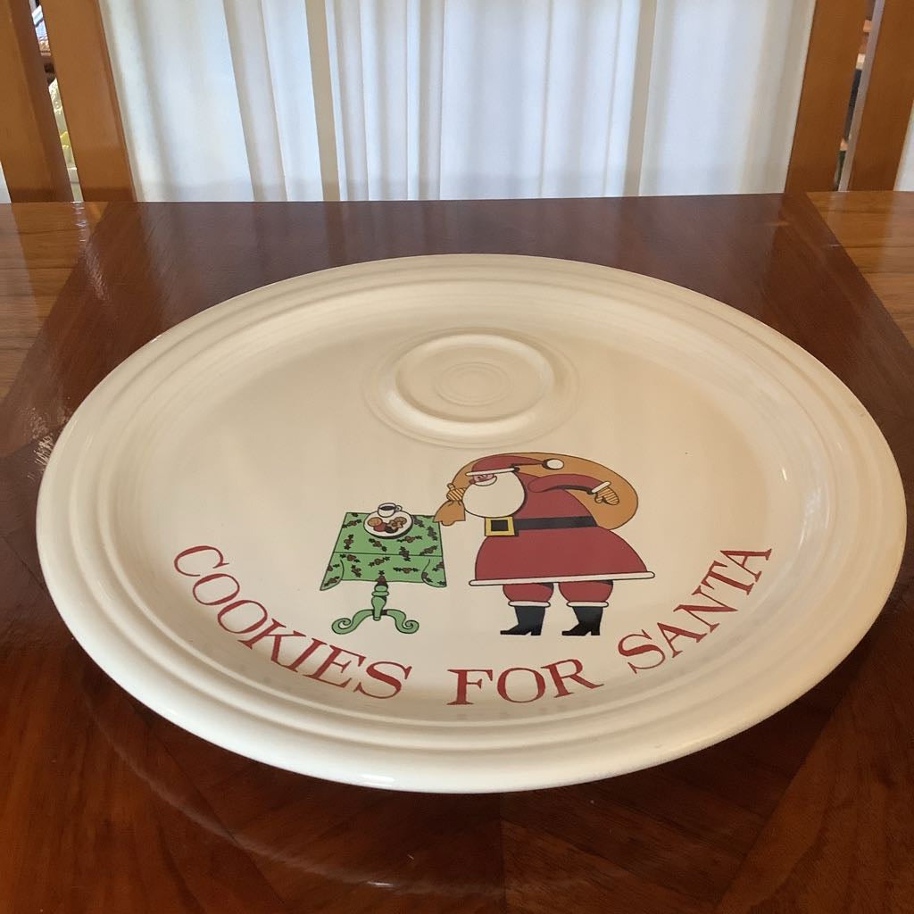 Decorative plate with 'Cookies for Santa' text and a cartoon Santa Claus on a wooden table.
