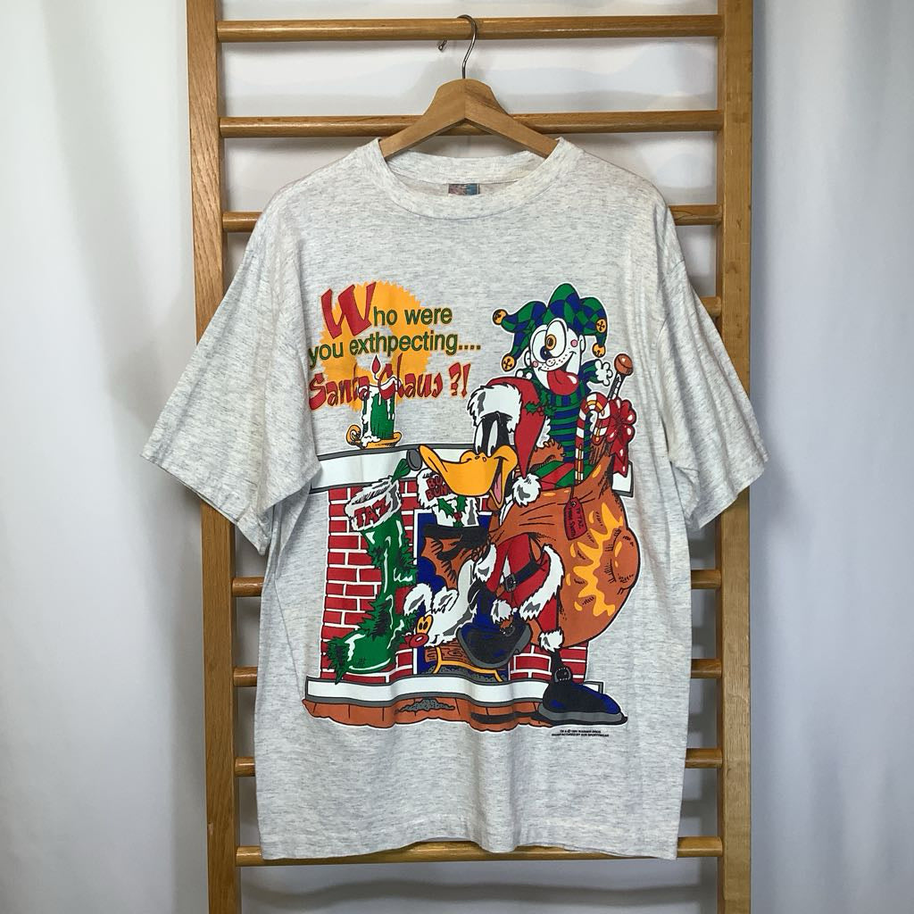 Gray t-shirt with a cartoon character design on a wooden rack