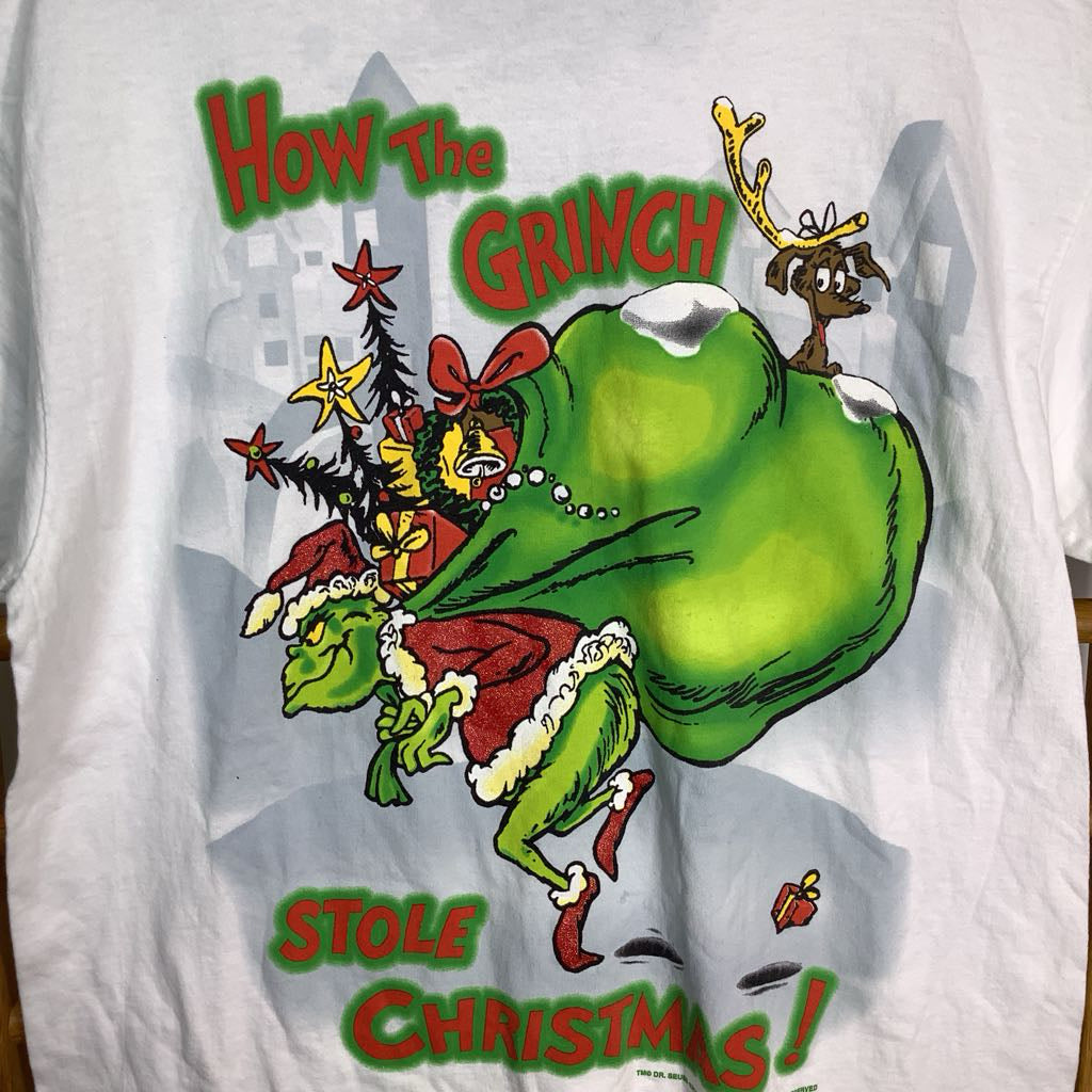 White shirt with a colorful Grinch graphic and text 'How The Grinch Stole Christmas' on a white background.