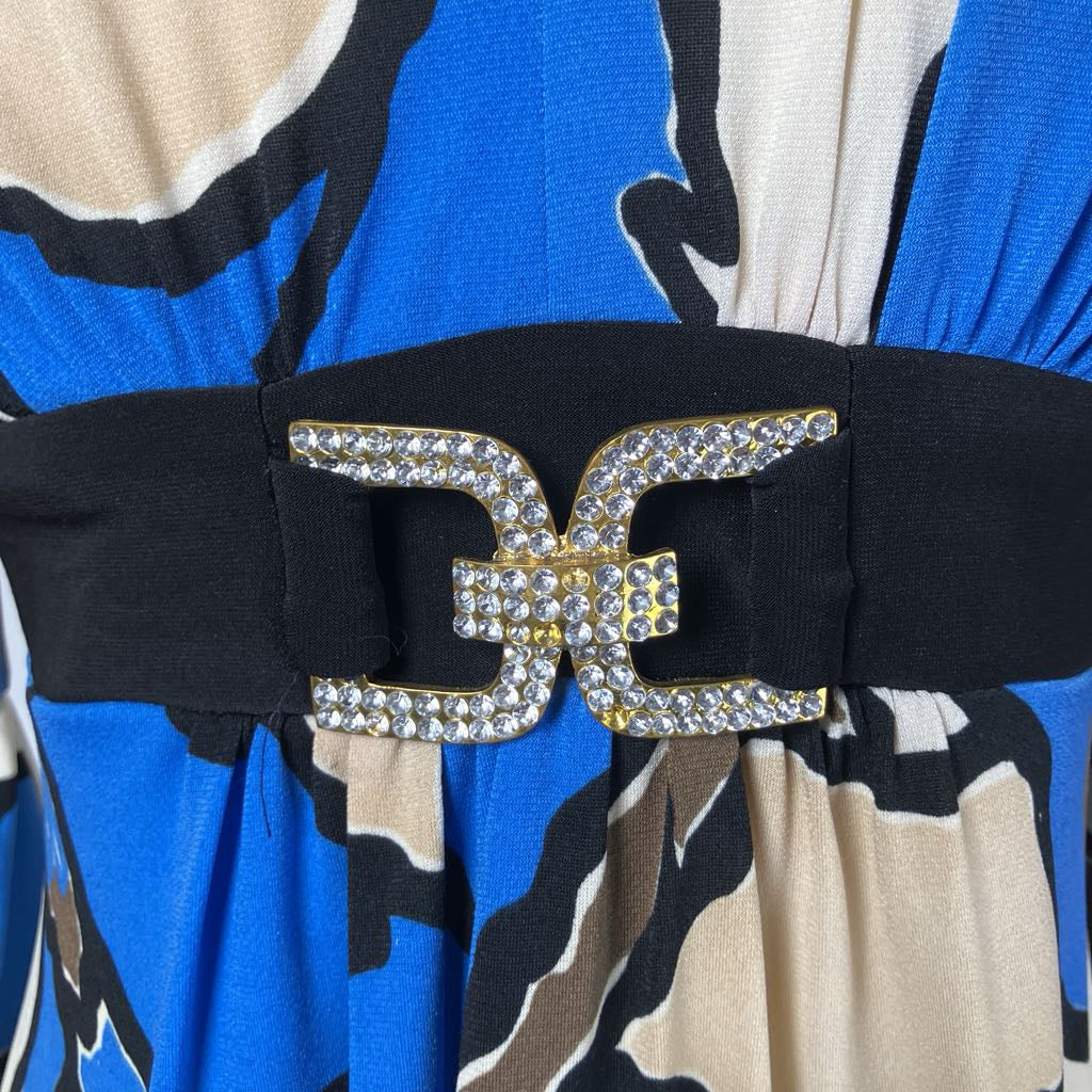 Blue and white patterned dress with a rhinestone buckle against a white background. 